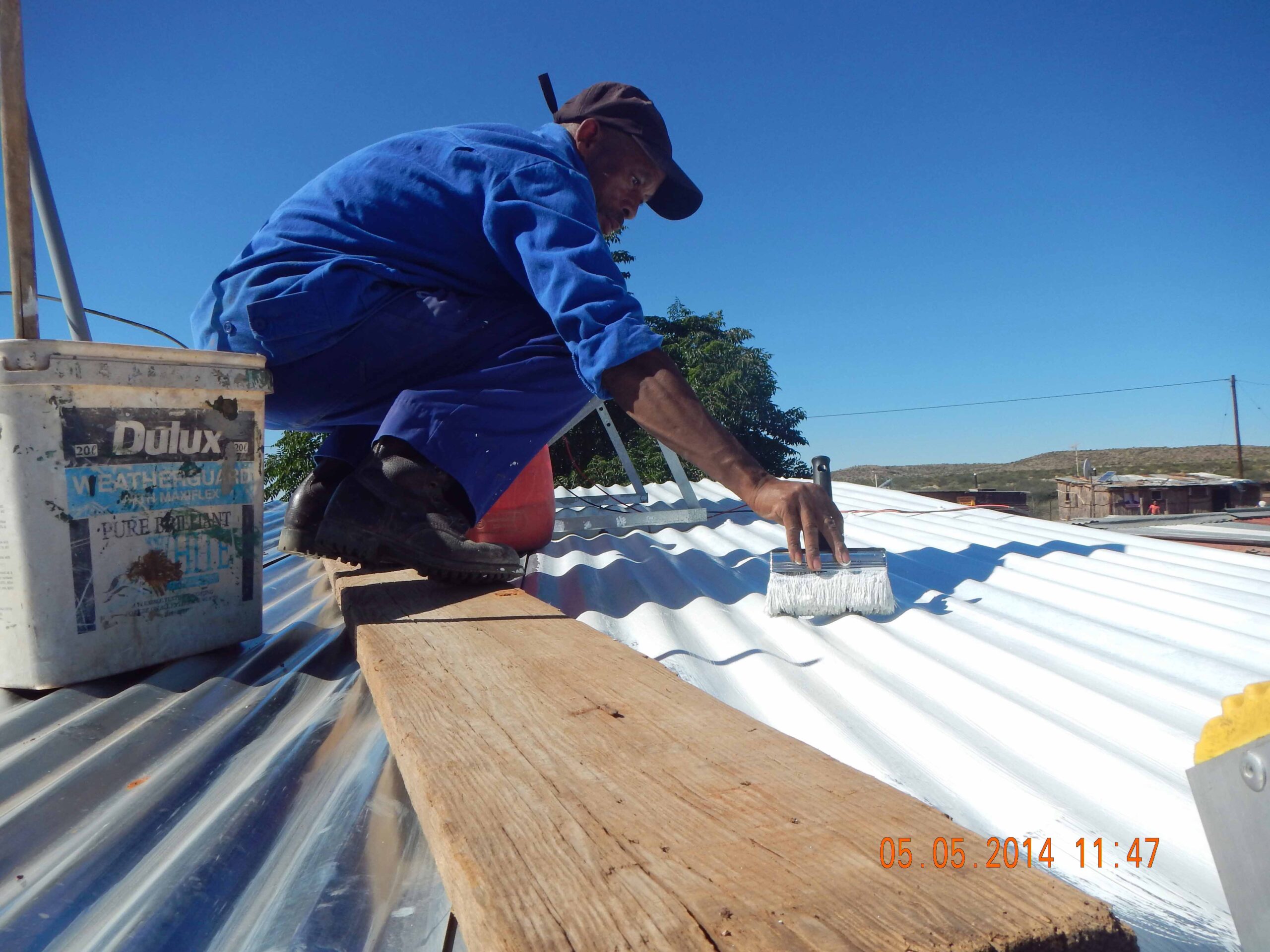 Person applying roof coating